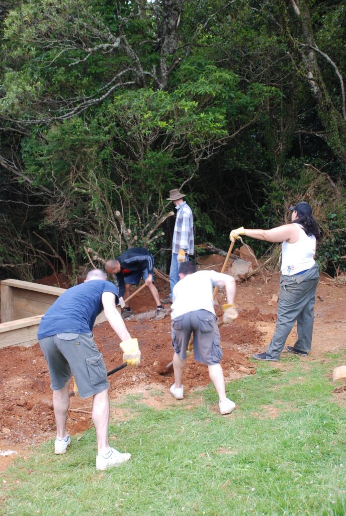 Community spirit and cooperation as a group of work colleagues assist at a special needs home to