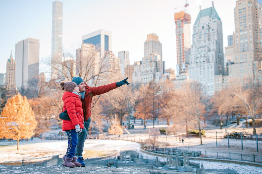 Family of father and kid in Central Park during their vacation in New York City